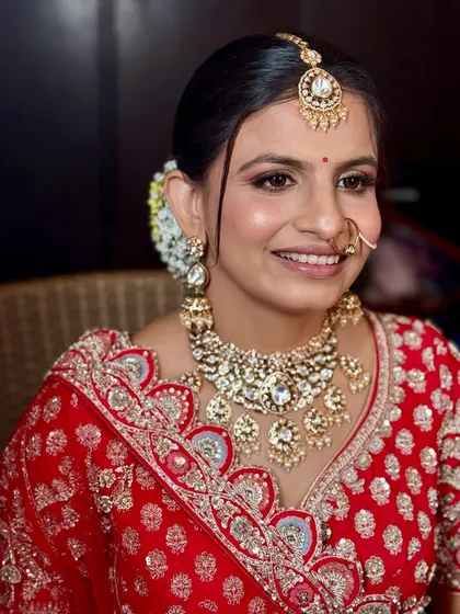 Another beautiful portrait of the bride, smiling and radiant. The makeup enhances her features without looking heavy.