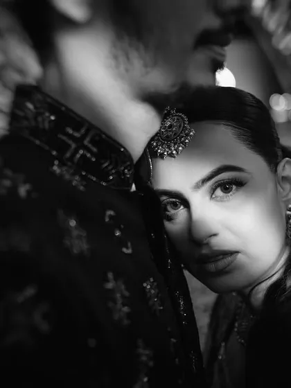 An intimate and artistic close-up. This black and white shot focuses on the bride's intense gaze, creating a powerful and emotional portrait.