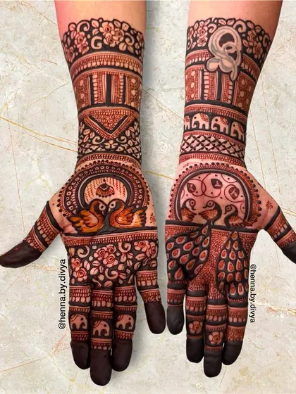 A classic and royal bridal design featuring traditional Indian motifs. This piece includes elegant peacocks, swans, elephants, and architectural jharokha patterns, perfect for a grand wedding.