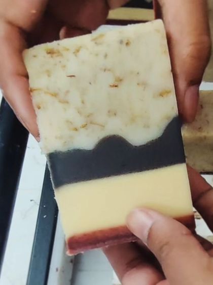 The cut of the soap made with natural colorant infusions, showing the distinct, earthy layers.