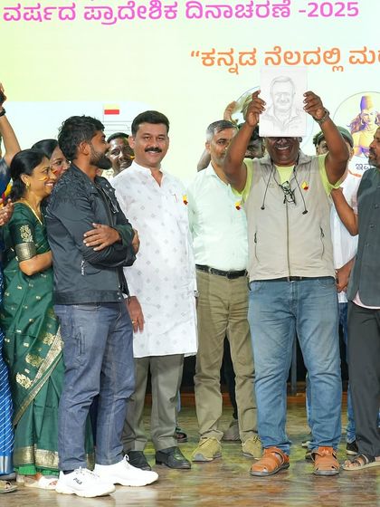 Presenting a live sketch to an esteemed guest on stage at a cultural event celebrating our Kannada language and heritage.