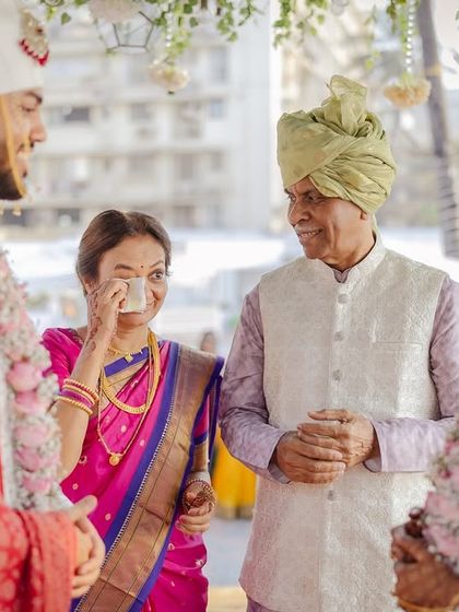 An emotional moment between the bride's mother and the couple. These are the memories that last a lifetime.