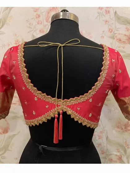 Another view of the red blouse with the zig-zag cutwork back, showing the clean lines and detailed embroidery.