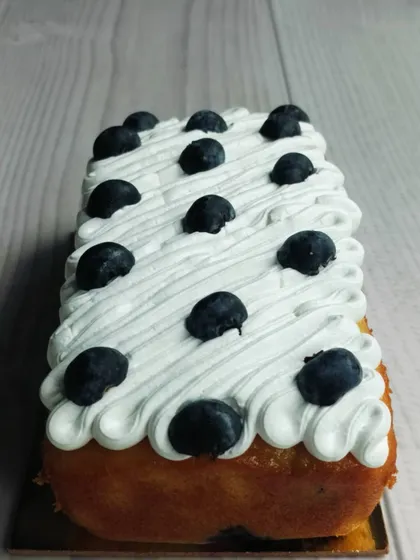 My Blueberry Tea Cake is a simple classic. The loaf is infused with fresh blueberries and topped with a light, airy whipped cream and more fresh berries.