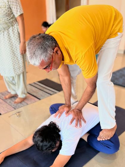 I demonstrate how to use body weight to provide a safe and effective adjustment in a seated forward bend.