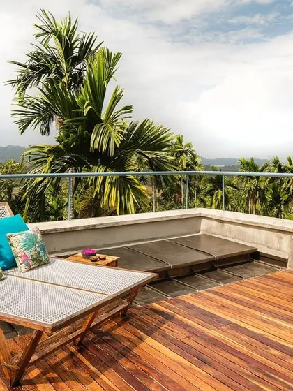 The spacious private terrace of the Tower Room, furnished for lounging and enjoying the expansive views over the rainforest.