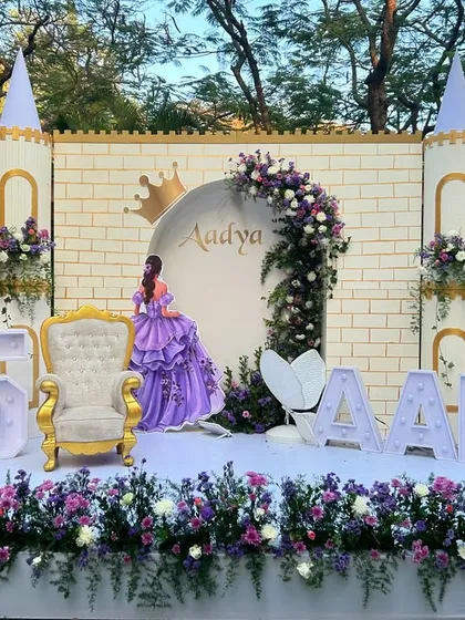 A princess party fit for royalty. We designed this grand castle backdrop with floral arches, a golden throne, and marquee letters for a truly magical fifth birthday celebration.