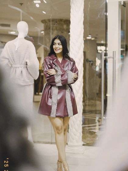 A candid moment in the burgundy coat. Winter fashion is all about feeling confident and warm.
