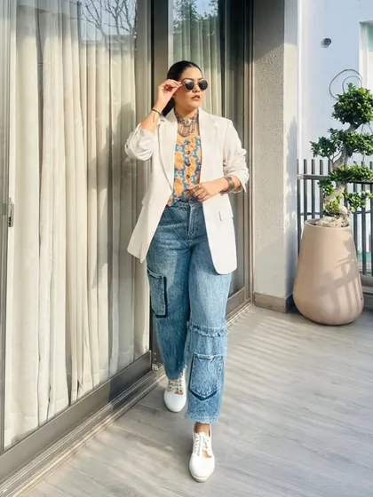Here is a perfect example of my signature Indo-western fusion. I've paired a traditional Bandhni print top with a crisp white blazer and relaxed cargo jeans. It's a look that feels both professional and uniquely creative.