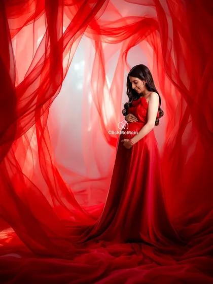 This is the moment I strive to capture. The pure elegance of motherhood, wrapped in a bold color that celebrates your strength. This portrait uses flowing fabrics to create a dramatic and timeless feel, focusing entirely on the beautiful connection between you and your baby bump.