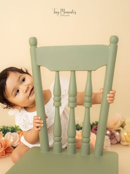 Another peek from behind the chair. These playful, candid moments make for the most memorable milestone photos.