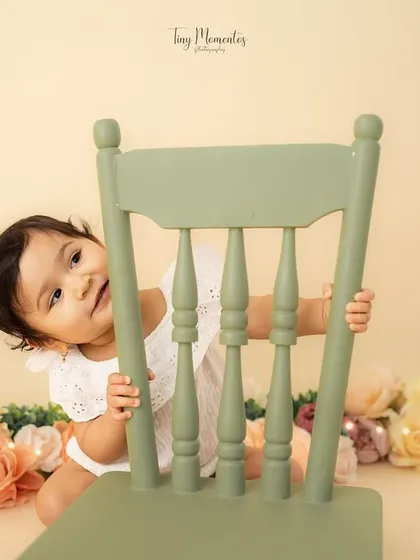 Another peek from behind the chair. These playful, candid moments make for the most memorable milestone photos.