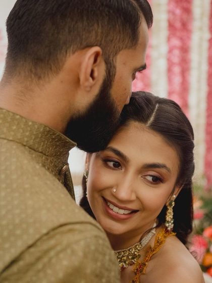 Childhood sweethearts on the first day of their wedding celebrations. Her Mehendi look is soft, radiant, and full of love.