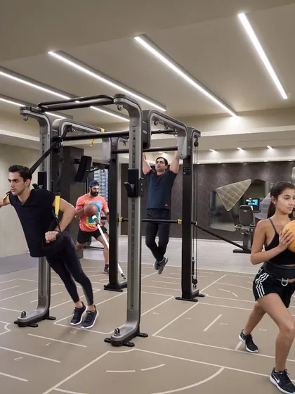 Our functional training area allows for dynamic, multi-faceted workouts. Here, clients use TRX, medicine balls, and pull-up bars simultaneously for a full-body challenge.