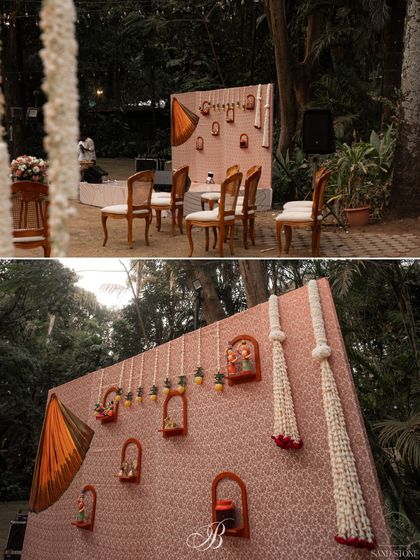 For this unique band backdrop, we started with a beautiful saree and layered it over repurposed brocade fabric. We then added DIY wooden frames holding Channapatna crafts and hand-painted pickle jars for a vibrant blend of old and new.