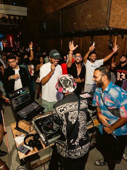 A wide shot showing the crowd gathered around the DJ booth. I love it when the party gets up close and personal.