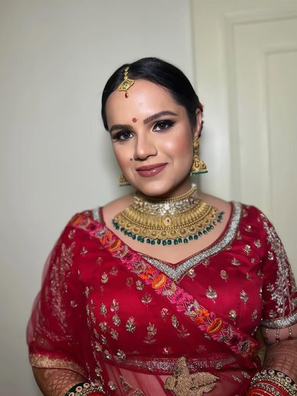 A close-up of the bride, her smile shining. The makeup enhances her natural beauty, making her look gorgeous.