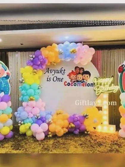 The Cocomelon theme is a huge favorite with toddlers. This is a complete Cocomelon stage setup I created, with character cutouts, themed balloon pillars, and a light-up number '1'.