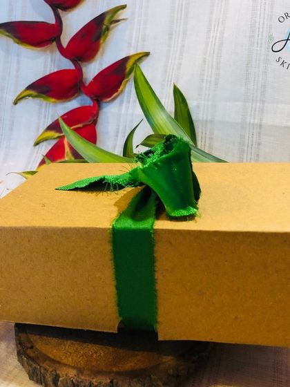 A beautifully wrapped Rakhi gift box, finished with a simple, elegant green ribbon. I believe the presentation is just as important as the gift inside.