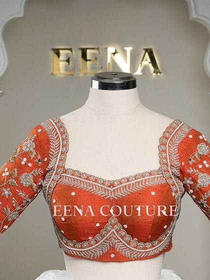 My signature Katori blouse in a festive burnt orange. This piece features contemporary silver and white floral embroidery on the sleeves, with delicate pearl detailing scattered across the body for a touch of bling.