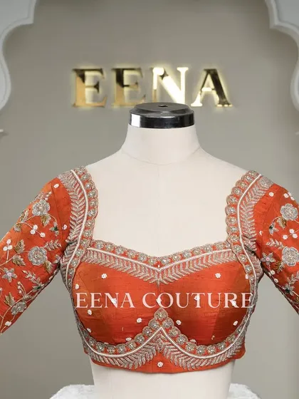 My signature Katori blouse in a festive burnt orange. This piece features contemporary silver and white floral embroidery on the sleeves, with delicate pearl detailing scattered across the body for a touch of bling.