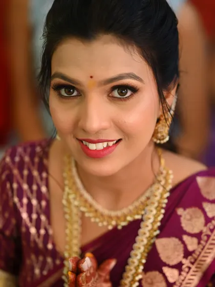 A close-up of the engagement bride, focusing on her bright, happy expression and the clean, defined makeup look.