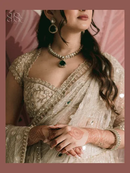 A detailed shot focusing on the bride's stunning outfit and jewelry. These photos celebrate the beautiful details you've chosen for your day.