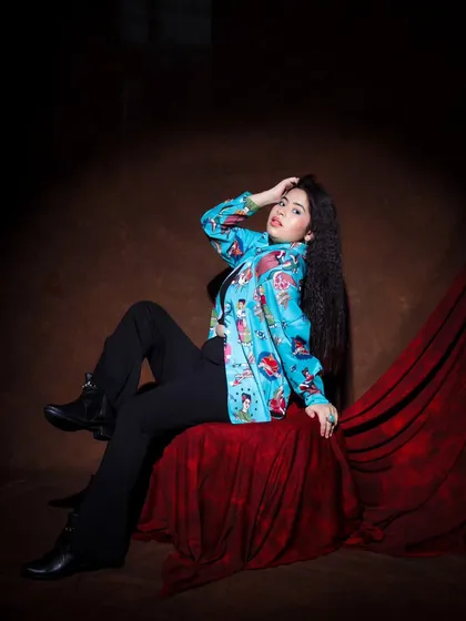 And it goes like this. A confident, relaxed pose in a quirky and colorful shirt, perfect for showcasing personality.