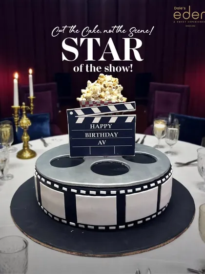 The star of the show! This movie-themed cake is designed as a film reel with a clapperboard on top, complete with edible popcorn. It's the perfect cake for a movie buff's birthday party.