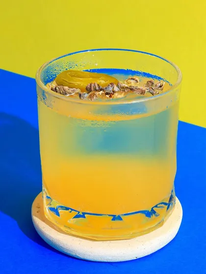 This yellow and blue combination is so striking. The colours in the background make the layered cocktail stand out, and the jalapeño garnish adds a hint of its spicy flavour.