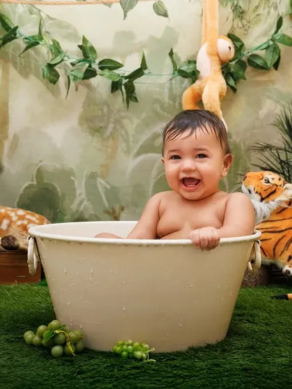 An absolutely joyful splash time photo! This baby's smile is infectious.