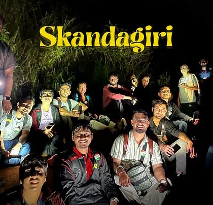 A group photo taken during the night portion of the Skandagiri trek, ready for the climb ahead.