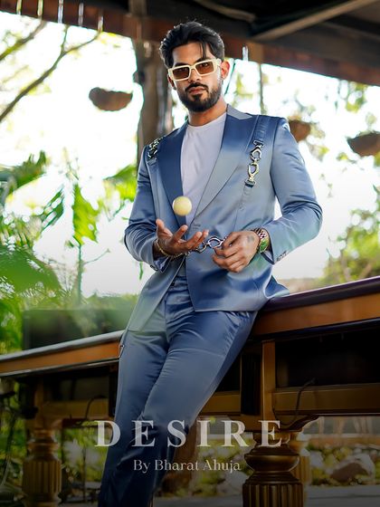 A moment of relaxed confidence. The light blue suit, paired with a simple white tee and sneakers, demonstrates its versatility for both formal and smart-casual occasions.