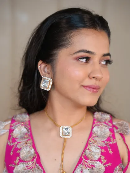 A side profile showcasing the soft pink eyeshadow and glowing highlighter. This romantic makeup is all about enhancing, not covering.