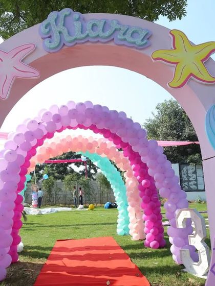 A closer look at the mermaid-tail balloon arch entrance, showcasing the detailed party decorations.