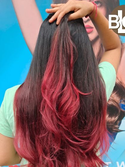 A pop of color with this red ombre style. This is a great way to add a bold statement to your hair without committing to a full head of color.