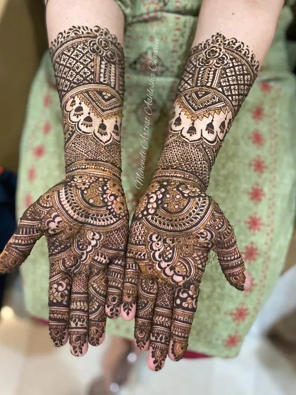 An intricate and dense mehendi design. The patterns are a beautiful mix of traditional motifs, perfect for a bride who wants a full and rich look.