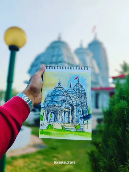 Holding up my finished watercolor and ink sketch against the actual Jagannath Temple. It's a great way to see the real-life inspiration behind the art.