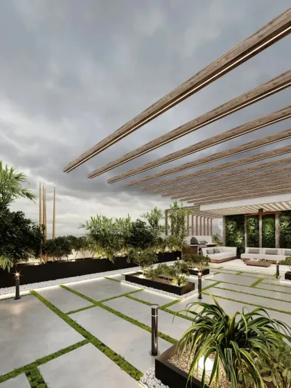 A wide-angle shot of the terrace, showcasing the expansive layout with modern planters and pathway lighting. The design is perfect for hosting larger gatherings.