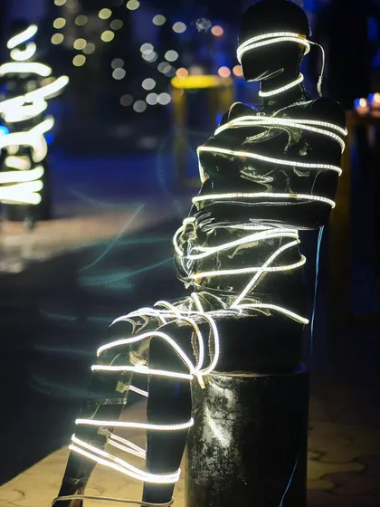 Another illuminated statue, creating an intriguing and modern art installation within the party space.