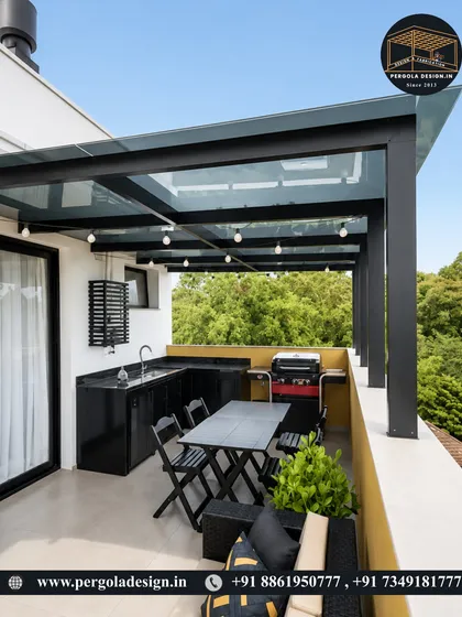 Even compact spaces can be transformed into functional luxury. This balcony features a sleek glass roof pergola, creating a stylish and protected outdoor kitchen and dining area, perfect for year-round grilling and entertaining.