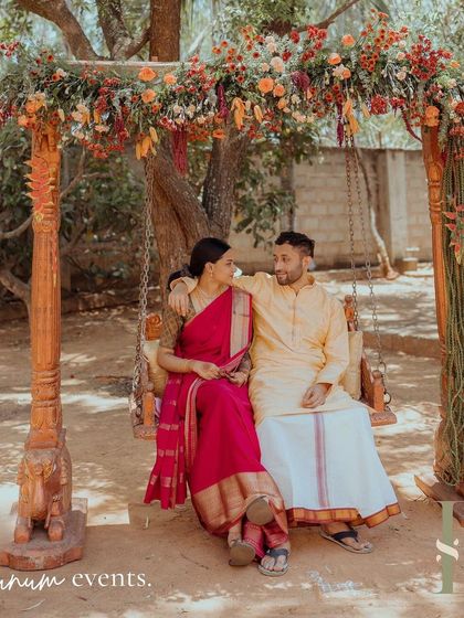 The couple shares a quiet moment on a traditional wooden swing (oonjal), which we decorated with rustic flowers to match their backyard wedding theme.