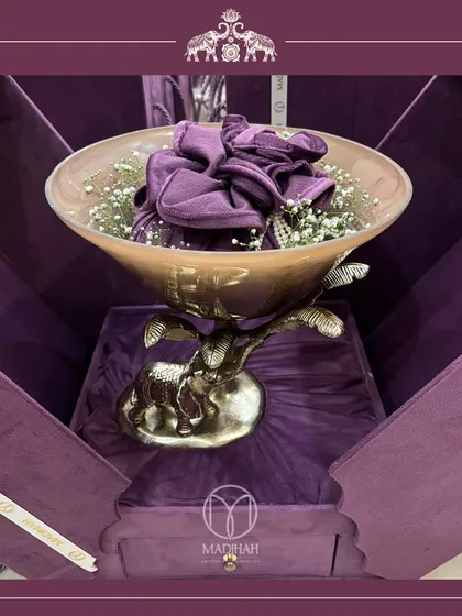 The Elephant Bowl presented in its deep purple, custom-designed hexagonal box. This unique packaging enhances the sense of luxury and makes for a grand presentation.