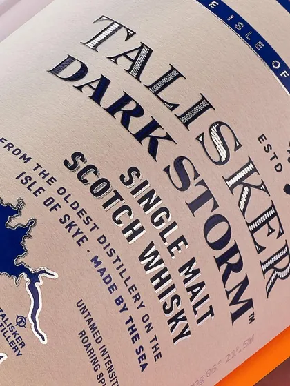 A close-up on the Talisker label. The silver, embossed text is the hero here. This kind of macro shot shows off the premium quality of the packaging.