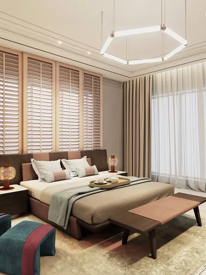 This daughter’s bedroom is a blend of warmth and elegance, with a custom bed in soft neutral tones of brown and pink. Pastel hues are elevated by a striking pop of color in the artistic lounge chair, adding a playful touch to the functional and stylish space.