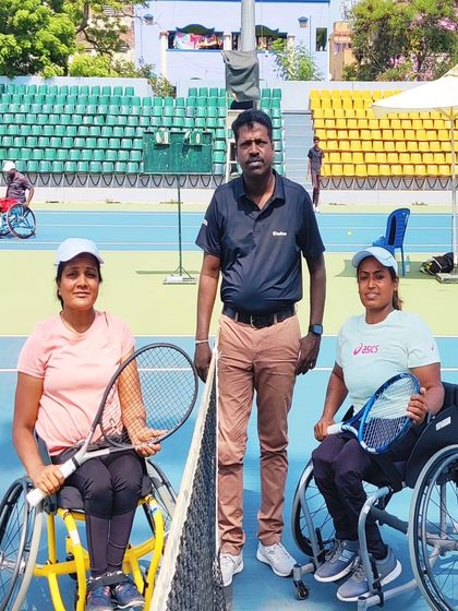 Our athletes with their coach on the court during the AITA Tennis Championship. We ensure our players have expert guidance and support at every tournament.