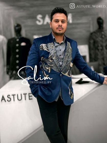 A client posing in the blue velvet blazer with a flying horse embroidery. The design is a conversation starter, perfect for social events and parties.