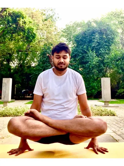 This challenging seated balancing pose, a variation of Tolasana (Scale Pose), requires lifting the body while in Padmasana (Lotus Pose). It cultivates deep core strength and a focused, unwavering mind.