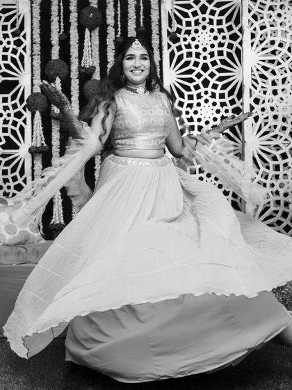 A beautiful black and white shot capturing the movement and happiness of the Mehendi ceremony. A timeless look for a timeless moment.