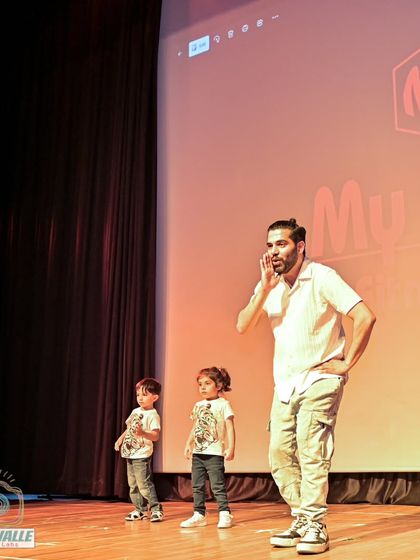 On stage with my students, guiding them during their performance. I am always there to support and cheer them on.